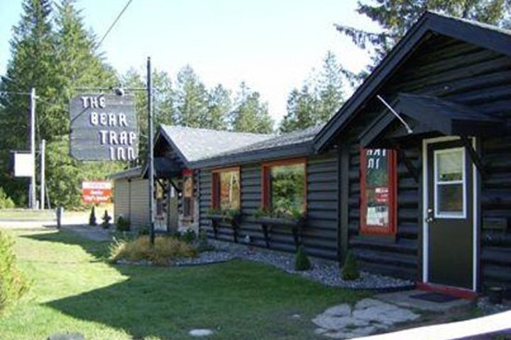 The log-sided Bear Trap Inn and its roadside sign
