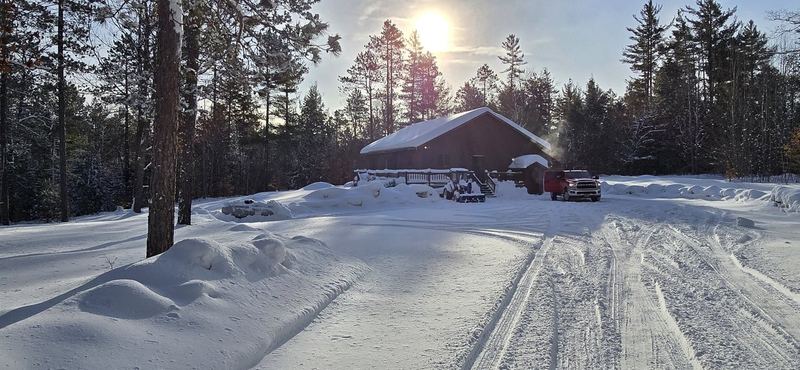 Cabin in snow with pickup truck